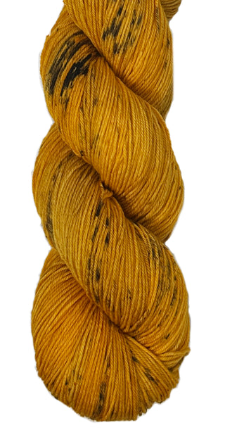 Tonal gold hand dyed yarn with black speckles from the Mixtape collection of music themed yarn colors for knittings and crocheters Hamilton