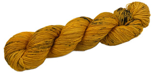Tonal gold hand dyed yarn with black speckles from the Mixtape collection of music themed yarn colors for knittings and crocheters Hamilton
