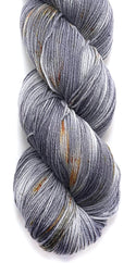 color details of a skein of hand dyed wool yarn for knitting and crochet in shades of gray and gold speckles lunar lander space color theme
