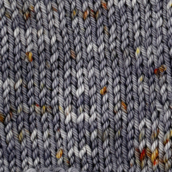 knit swatch of hand dyed wool yarn for knitting and crochet in shades of gray and gold speckles lunar lander space color theme