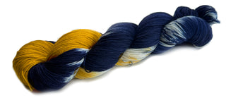 hand dyed wool yarn dark night navy blue white and gold colors. voyager 1 spacecraft themed with stars and golden record for knitting and crochet